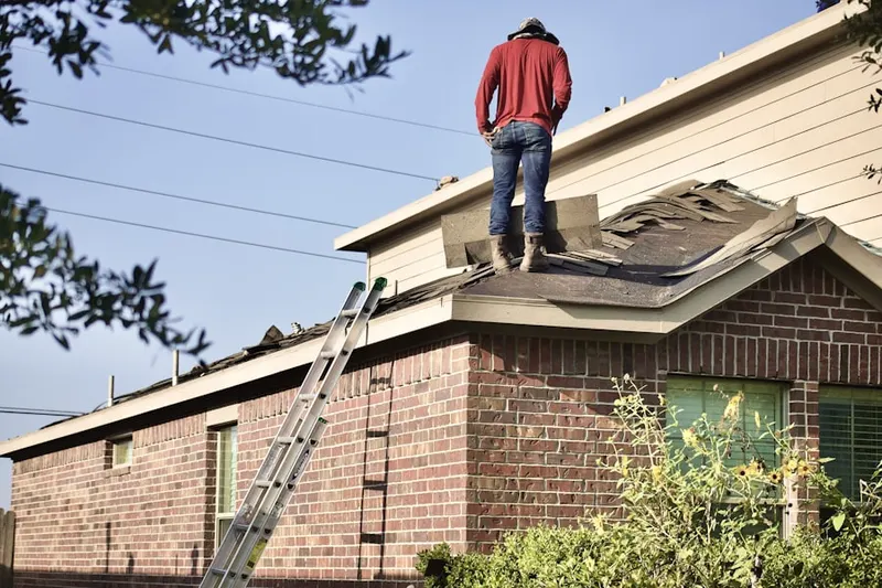 Professional roofer working on a residential roof in Riviera Bay